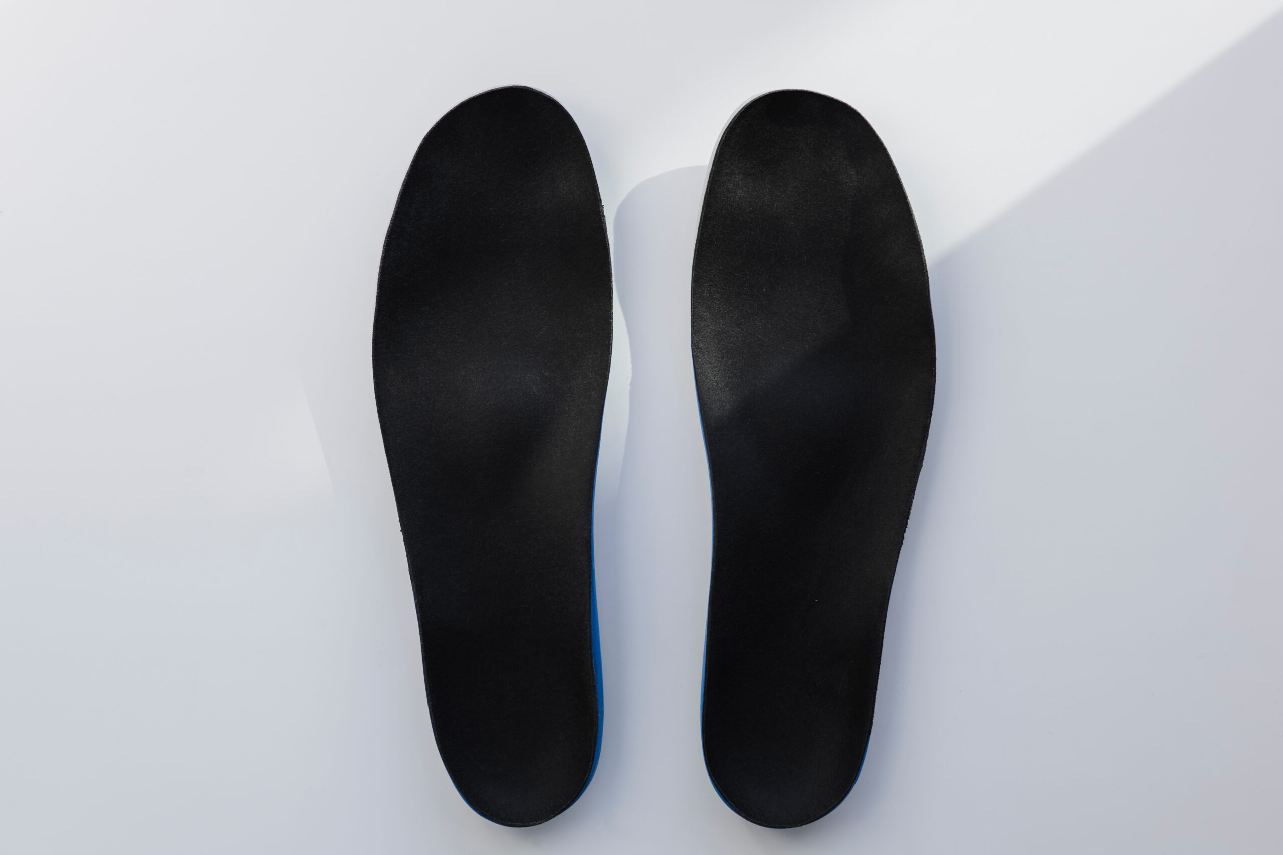 Top view of black pair of XO-SOLE insoles isolated on white background.