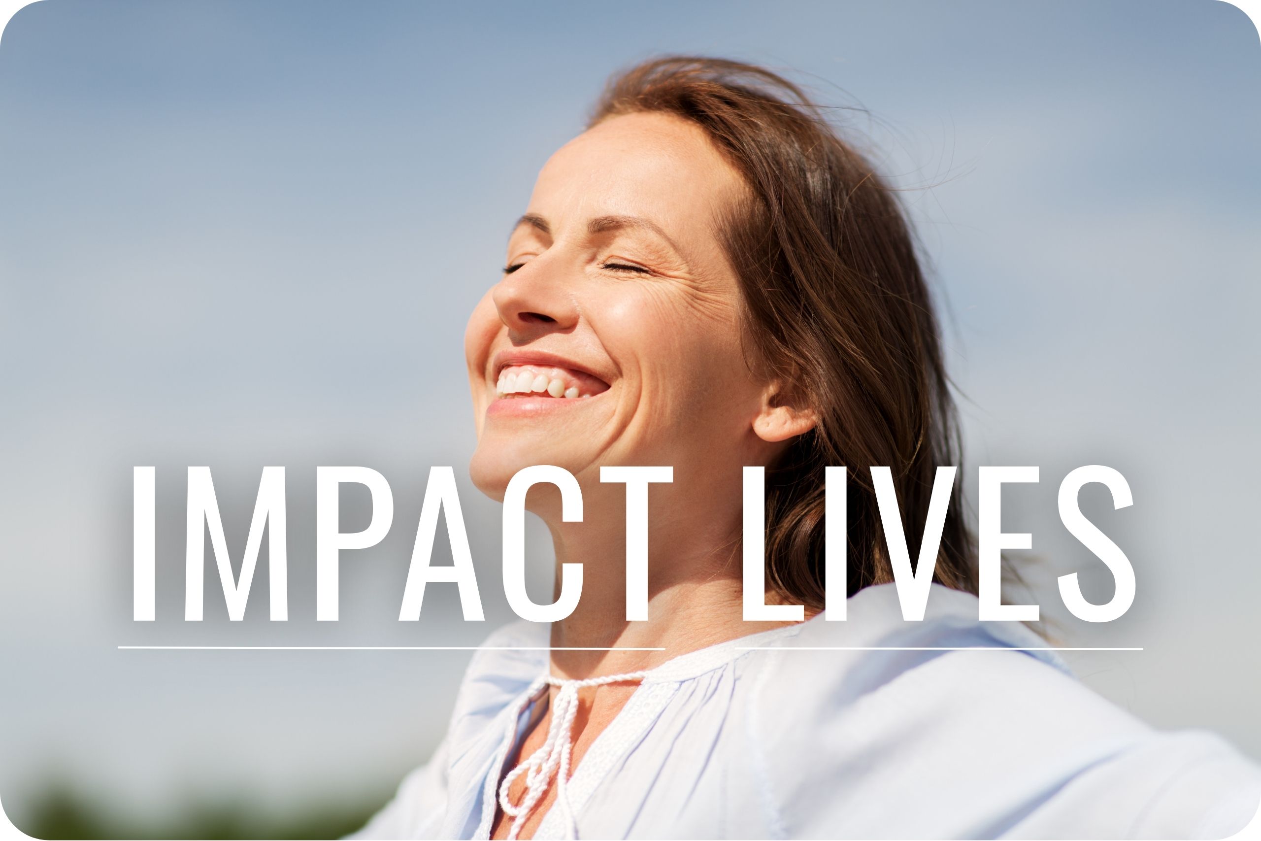 Impact Lives A woman smiling as the sun beams on her face.