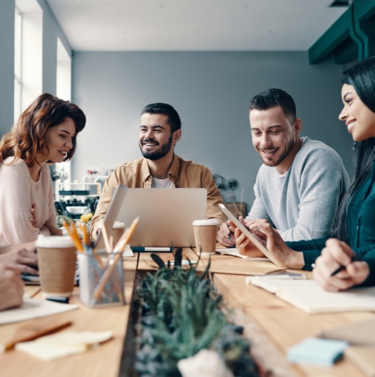 A group of coworkers at a table, collaborating on a project.