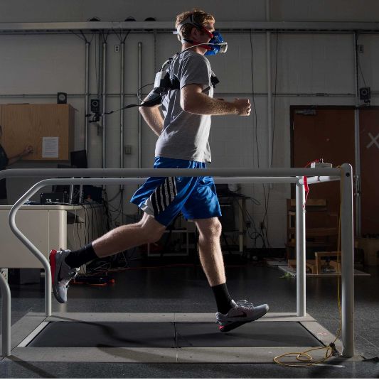 Male Athlete on Instrumented Treadmill Male athlete running on an instrumented treadmill during a biomechanics study.