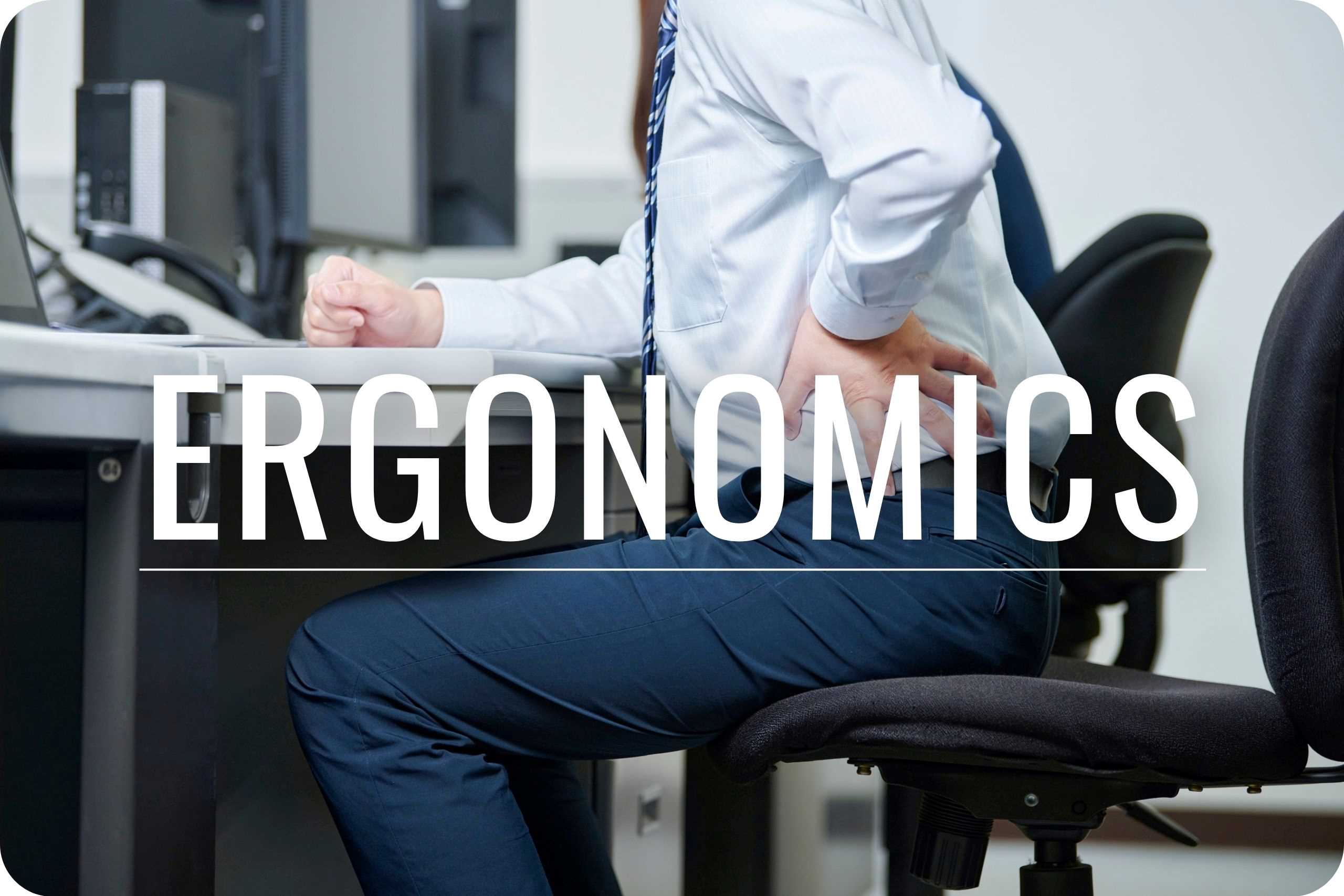 Ergonomics An office worker clutching their lower back in pain.