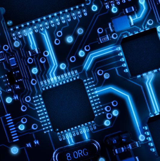 A printed circuit board in blue lighting.