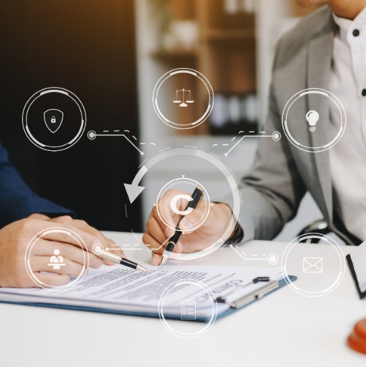 Two individuals going over a patent document.