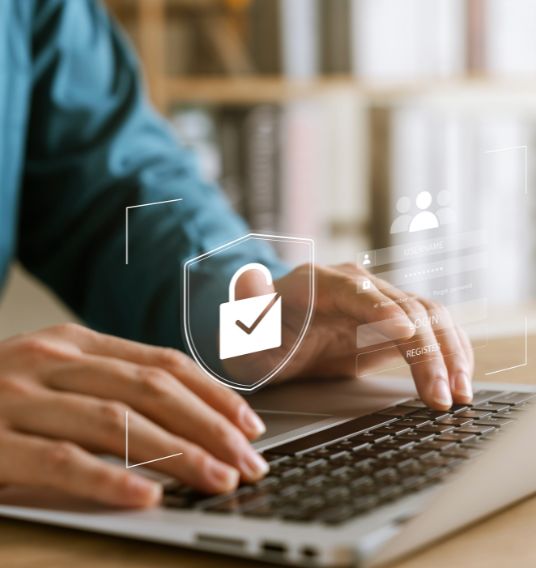 A person typing personal information into their computer.