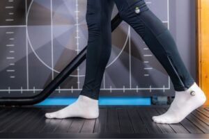 A person having their walking patterns analyzed in a physical therapy clinic.