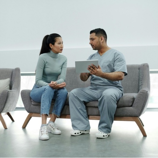 A physical therapist consults his client.