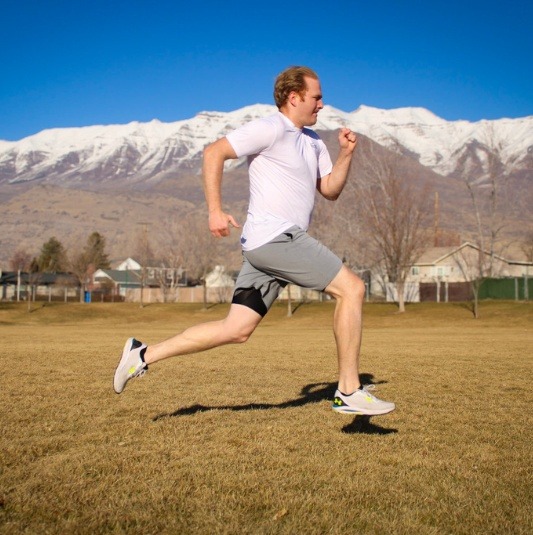 Capturing 3D GRF Outside the Lab Male athlete running in a field with Mount Timpanogos in the background.